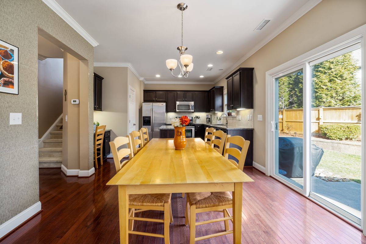 A bright dining room with a wooden table in a family home.